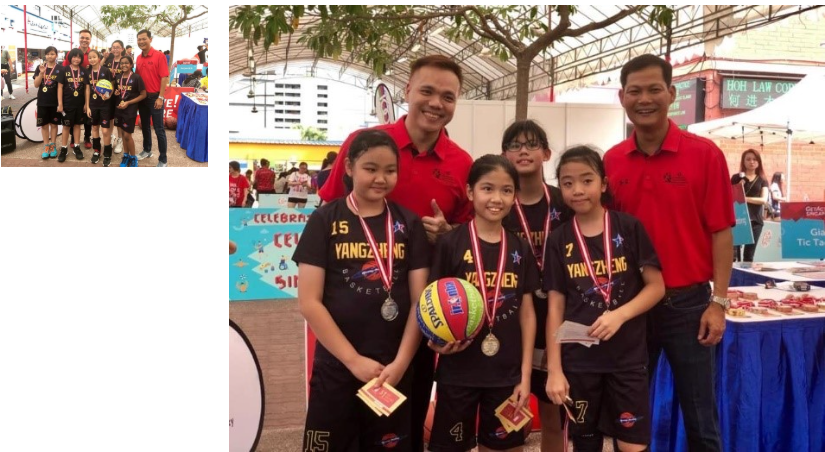 A group of primary school girls basketball players posing with the event organisers